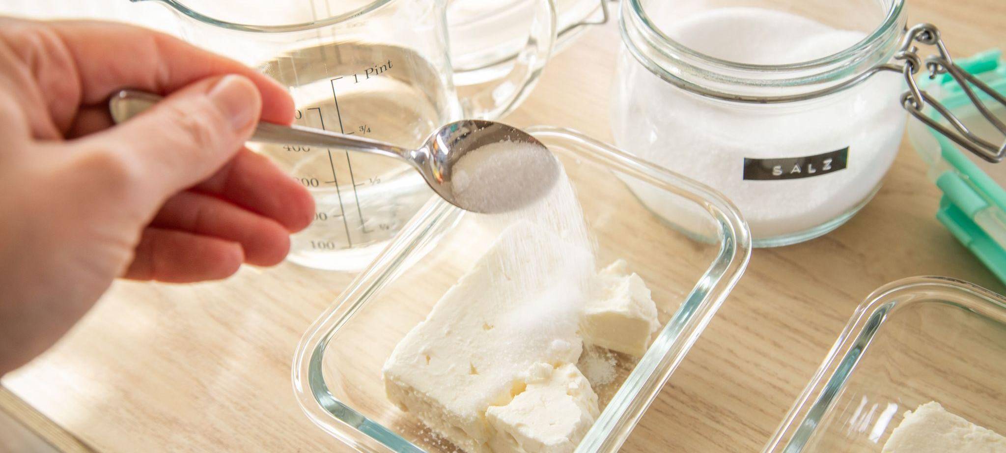 Feta in einer Schale wird gesalzen